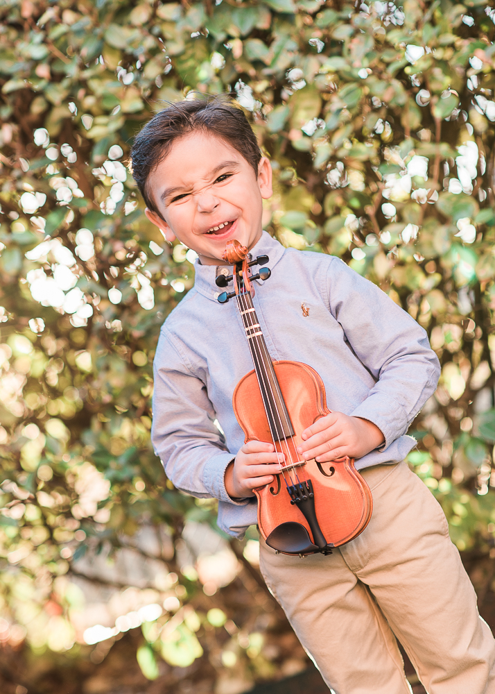 Little boy holding violin by Keli Melo family portraits in Plano